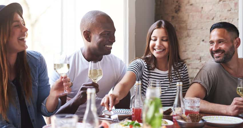 A group of friends drinking and eating