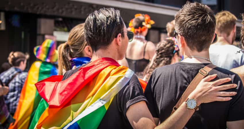 A group of people attending a LGBTQ Pride Parade