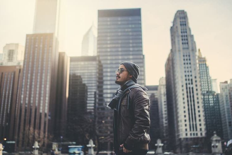 Man in Chicago with buildings in background