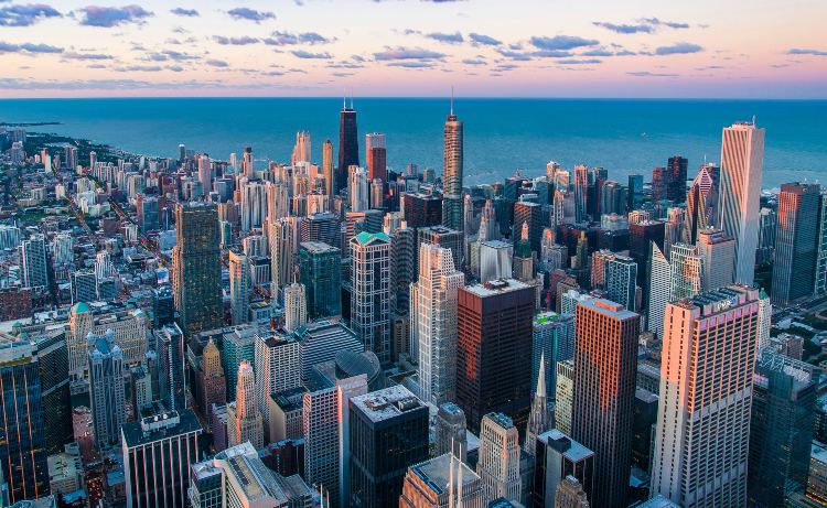 a view of the chicago skyline with water in the background